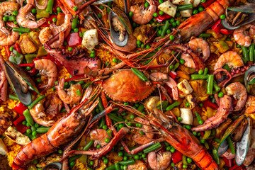 Paella. Spanish dish of rice and seafood, vegetables and chicken. Shrimp, octopus, crab and mussels. Banquet festive dishes. Gourmet restaurant menu. White background. Pattern
