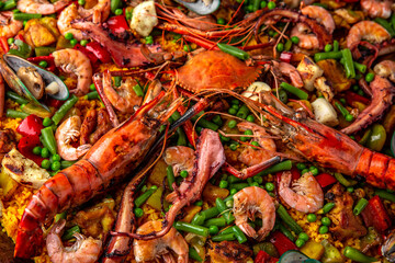 Paella. Spanish dish of rice and seafood, vegetables and chicken. Shrimp, octopus, crab and mussels. Banquet festive dishes. Gourmet restaurant menu. White background. Pattern