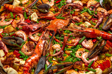 Paella. Spanish dish of rice and seafood, vegetables and chicken. Shrimp, octopus, crab and mussels. Banquet festive dishes. Gourmet restaurant menu. White background. Pattern