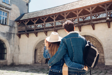 Couple of tourists walking in Olesko Castle yard admiring ancient architecture. Travelling in Western Ukraine. © maryviolet