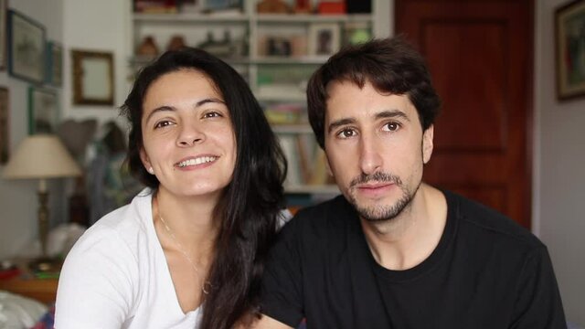 Young couple giving testimony in front of camera, people vlogging speaking
