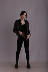Brunette woman with a gun in her hand
