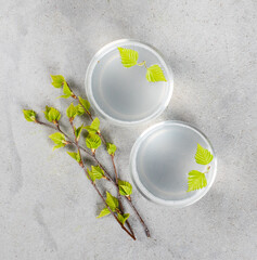 Russian traditional drink, natural birch juice in a glass on a light gray background top view