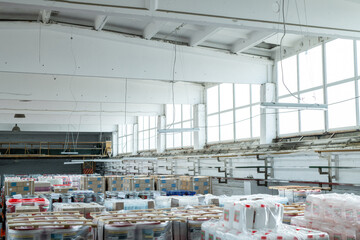 Large warehouse with canisters wrapped into polyethylene