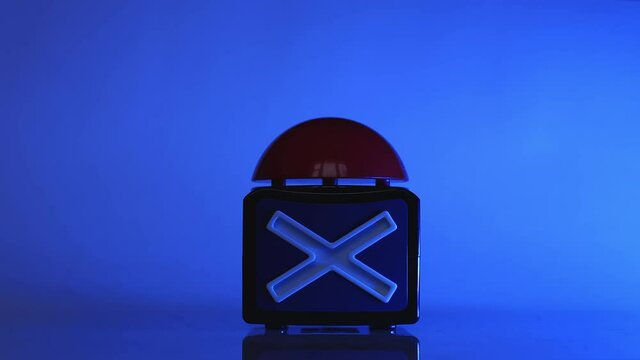 The hand presses a large red button