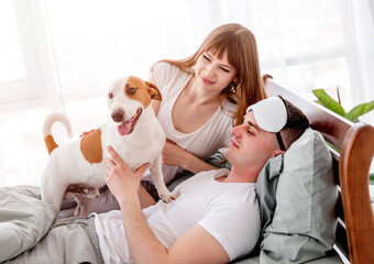 Obraz na płótnie Canvas Couple in the bed with dog