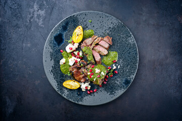 Modern style traditional barbecue T-Bone lamb steaks with Greek feta cheese, chimichurri sauce and...