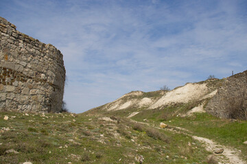View of a fragment of the ancient wall of the Genoese fortress and a mountain in the vicinity of Feodosia in the Crimea.