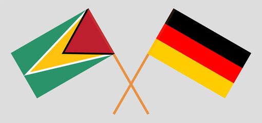 Crossed flags of Guyana and Germany. Official colors. Correct proportion.