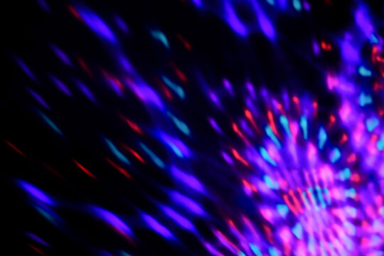 Blur colorful neon light leaks on black background. Defocused illuminated abstract futuristic texture for using over photos as overlay or screen filter