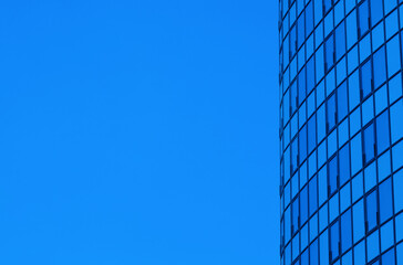 Fototapeta na wymiar SIde part of skyscraper at sky background