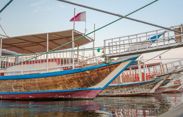 Fototapeta na wymiar Traditional dhows parked together in Doha Corniche.