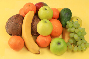 Fresh summer tropical fruits on a bright sunny table, citrus mix, detox diet and weight loss concepts, banner, advertisement for the store. Top view, healthy and natural food, source of vitamin C,