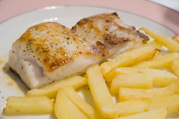Fillet of cod fish with fries on plate Basque country Spain