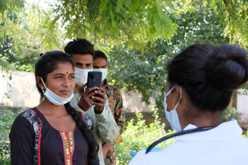 Group of young Indian people listening carefully to the instructions of a health care worker