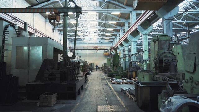 Large industrial workshop factory interior with machines and lathes for processing metal production.