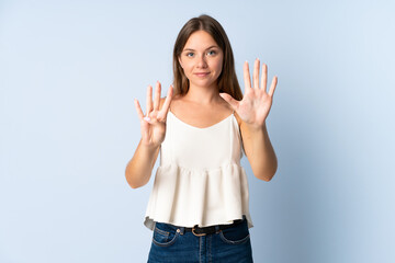 Young Lithuanian woman isolated on blue background counting nine with fingers