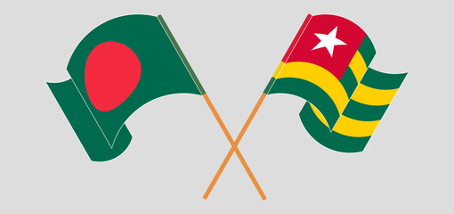 Crossed and waving flags of Bangladesh and Togo