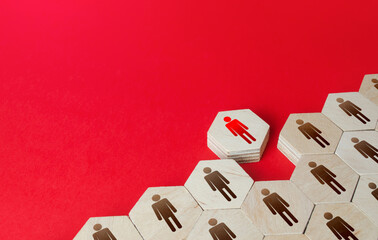 A man leaves a formation of people figurines hexagons. Violation of the integrity of the system,...