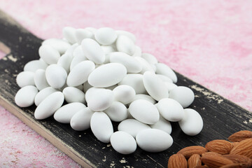 Close up of a group of white sugared almonds. Almond candies. Candies background top view, almond...