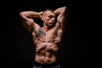 Fototapeta premium Young bodybuider posing in studio