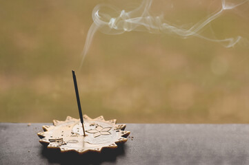 Obraz na płótnie Canvas Aromatic incense burning on a windowsill