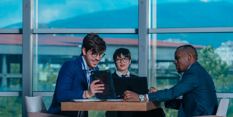 Female manager leads brainstorming meeting. Businesswoman in meeting with colleagues in conference room.