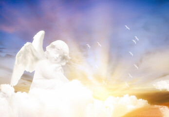 Angels in the clouds. Cloud background with bright colors and sun rays.