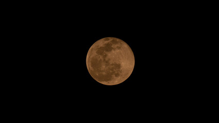 Full moon over dark black sky at night. Selective focus