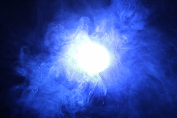Fototapeta na wymiar Artificial smoke is illuminated with blue bright light