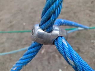 blue rope cables fastened together with a metal fastener