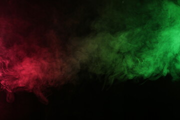 Smoke in red-green light on black background