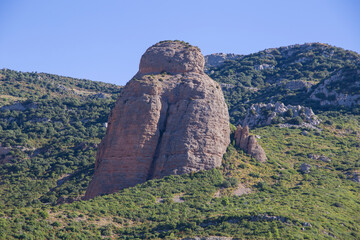 Landscape of the Mallos de Riglos (famous geological formations) with the town of Riglos, in the province of Huesca Aragon, Spain