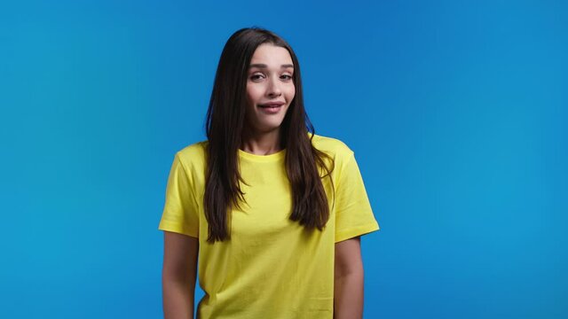 Young woman showing gesture of nonsense, not serious. You're kidding, no way. Hispanic lady reaction to pleasant compliment over blue background.