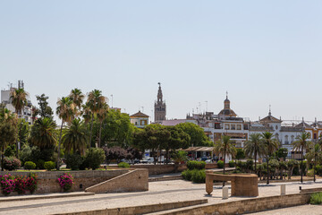 Fototapeta na wymiar Views from the banks of the Guadalquivir river part of the Giralda of Seville, Spain