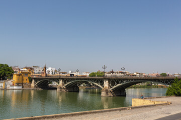 Fototapeta na wymiar Views of the Triana bridge over the Guadalquivir river in Seville, Spain