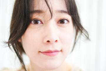 Fototapeta premium 笑顔でメイクをする若い女性