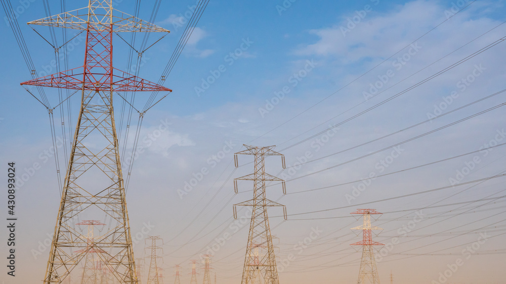 Wall mural high voltage electric towers during sunset.