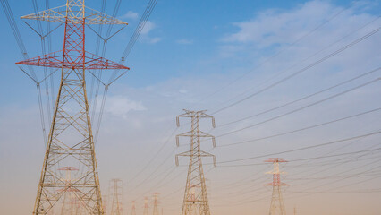 high voltage electric towers during sunset.