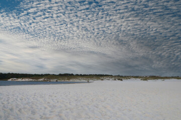 winter clouds above white sand at gulf beach