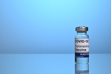 Covid vaccine jar with copyspace on blue gradient background. Covid-19 vaccination jar. Covid...