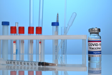 Russian Covid-19 vaccine vial on a lab desk. Chemical glassware and test tubes for pharmacy development. Medical test of coronavirus inoculation fluid. Chemical research laboratory with flasks.