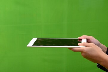 hand gesture with gagjet, mobile phone or tablet,  representing work with technology.