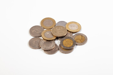 Heap of old coins of different countries on a white background