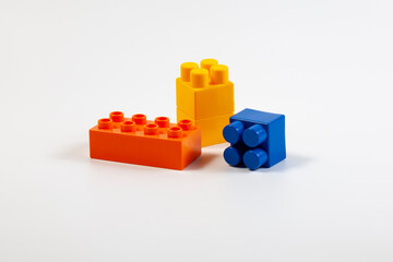 Fototapeta premium Multicolored blocks of children's constructor on a white background