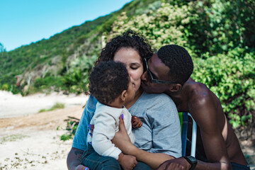 Family kiss at beach