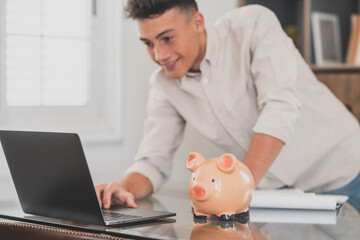 Man sit at desk manage expenses, calculate expenditures, pay bills online use laptop, makes...