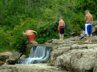 children jumping into a river