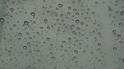 Rain drops are sticking with the glass.