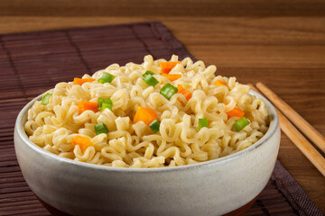 Bowl with instant noodles on the table.